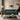 A classic tufted Chesterfield sofa in deep teal velvet, styled in a luxurious, warm-toned living room