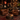 A cozy, dimly lit bar lounge featuring two brown leather Chesterfield armchairs facing a round metal coffee table with a glass decanter and candle. In the background, a dark wood bar is lined with bottles and lit by hanging lamps and a glowing red neon sign that reads 'Whiskey Helps'.