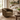 An olive green velvet swivel armchair in a bright, modern farmhouse-style living room with a white sofa, wooden coffee table, and natural light from a window.