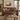 Westend aged leather loveseat sofa in a rustic living room setting, styled with decorative pillows