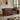 Westside leather Chesterfield loveseat sofa with tufted button detailing, nailhead trim, and turned legs, styled in a classic living room setting with a floor lamp, marble side table, and window.