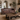 Aged leather Chesterfield loveseat sofa in a styled living room setting with a wooden coffee table, fireplace, and neutral walls.
