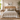 A beautifully styled bed in a warm, bohemian bedroom setting. The bed features a natural woven rattan headboard, dressed in cream linen bedding, white pillows, and a sage green textured lumbar pillow.